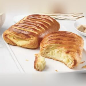 Baked cream cheese danishes, one broken open to show the cream cheese filling