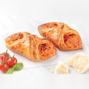 Two baked tomato parmesan croissants with cherry tomatoes and parmesan